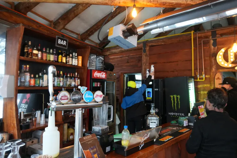 Wooden bar with a bartender serving drinks