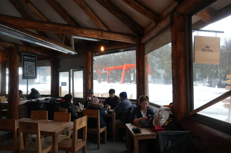 Mountain lodge dining room with large windows onto the snow